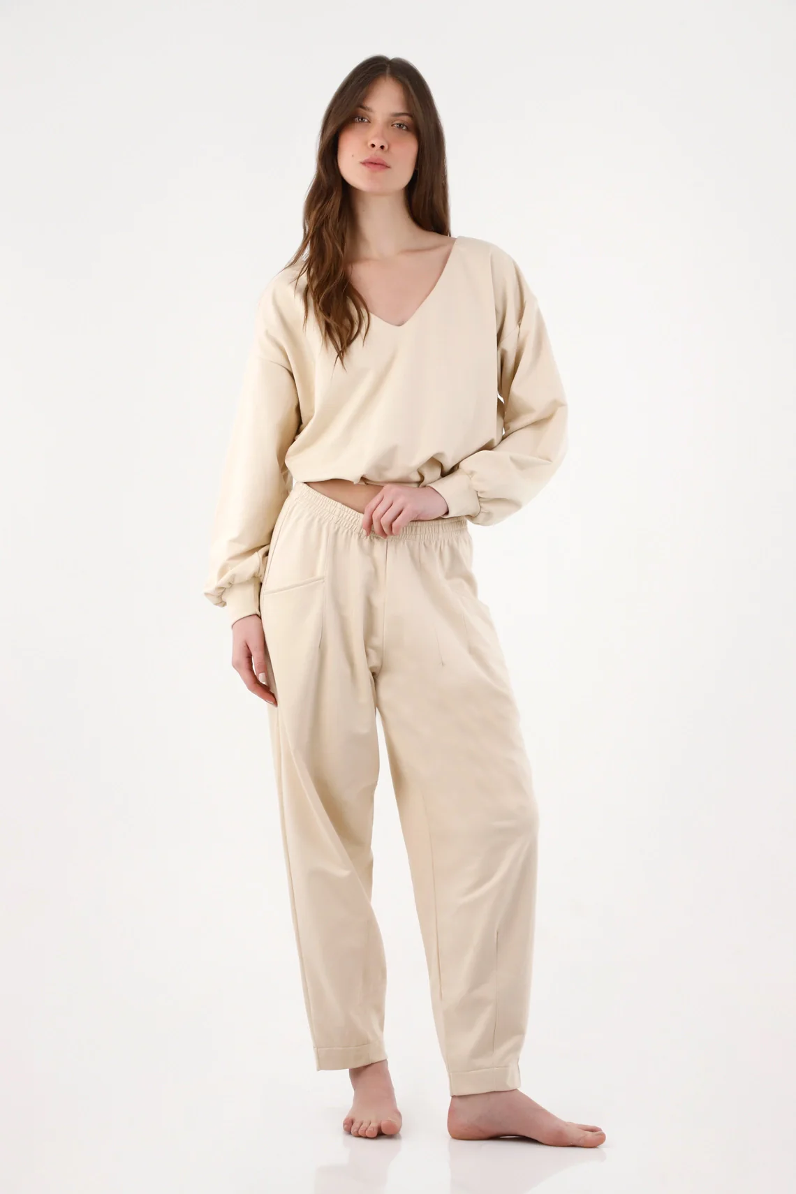 Women’s beige cotton pants with a relaxed fit and an elastic waistband